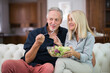 © Minerva Studio - Couple eating a mixed salad in their apartment