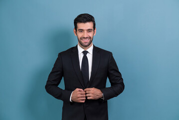 Stylish businessman in black suit posing confidently on isolated background, with a happy and optimistic smile as success and professionalism for businessman. Fervent