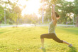© Jirawatfoto - Female jogger. Fit young Asian woman with green sportswear stretching muscle in park before running and enjoying a healthy outdoor. Fitness runner girl in public park. Wellness being concept
