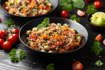 Wall Mural - Red and white quinoa tabbouleh salad with tomatoes, paprika and mint. Vegetarian, vegan food concept