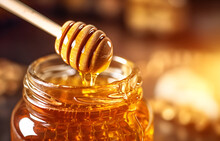 A Wooden Spoon Dips Into The Jar, Extracting Liquid Golden Honey.