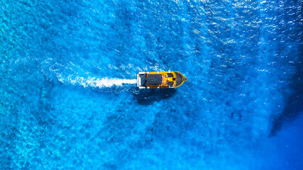Wall Mural - wave and boat on the sea as a background. .reef and waves from top view. turquoise water background 