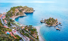 Isola Bella In Taormina, Sicily, Italy. Aerial View Of Small Beautiful Island Connected With Narrow Path With Beach. Scenic Landscape Of Sicilian Rocky Coast In Ionian Sea. Popular Travel Destination
