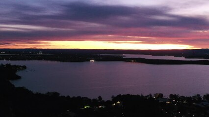 Sticker - panning along shores of Lake Macquarie at sunset in 4k aerial timelapse.
