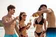 © Kawee - Group of diverse friends drink champagne while having a party in yacht.