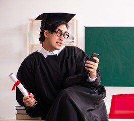 Wall Mural - Graduate student in front of green board