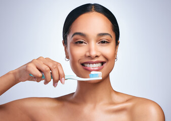 Wall Mural - Woman, brushing teeth and studio portrait with smile for self care, dental wellness or health by white background. Girl, dentistry model and toothbrush with toothpaste, product and happy for cleaning