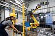 © Westend61 - Maintenance engineer operating robotic arm in factory