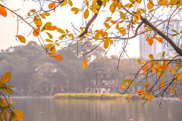 Wall Mural - Hoan Kiem Lake ( Ho Guom) or Sword lake in the center of Hanoi in the fog in the morning. Hoan Kiem Lake is a famous tourist place in Hanoi. Travel and landscape concept. Selective focus.