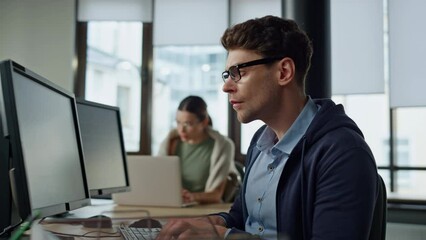 Software engineer working office. Focused man developer typing desktop computer