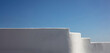© Rawf8 - Exterior white building empty wall touches blue sky background, Greece Cyclades island. Copy space