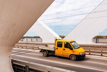 Yellow Mini Truck Speeding Over Modern Bridge, Used In Intra-city Low Tonnage Cargo Delivery,