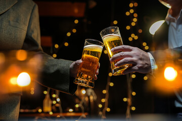 food and drink male friends are happy drinking beer and clinking glasses at a bar or pub.