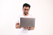 © MD - Image of a young cheerful businessman in a wristwatch holding and using a laptop. Men with laptops isolated over white background.