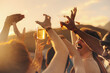 © Jacob Lund - Crowd of people dancing and celebrating with drinks at a music festival