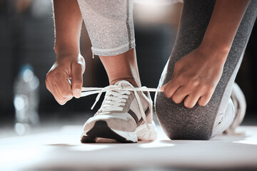 hands, shoelaces and floor at gym with woman, fitness and ready for workout, wellness or training. g