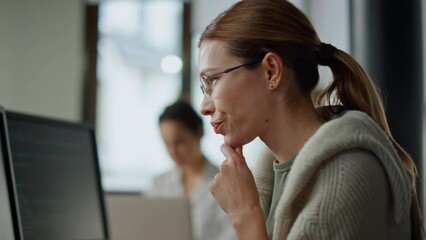 Woman developer checking code closeup. Focused software engineer work computer