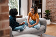 © Micah C/peopleimages.com - Relax, conversation and mother with daughter on sofa in living room for communication, empathy and support. Gossip, helping and discussion with woman and girl in family home for trust and bonding