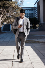 Poster - Phone, city and Indian business man walking for travel, social media or internet search. Smartphone, texting and male person on walk in town while checking app, message or text on commute in street