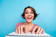 © deagreez - Portrait of ecstatic funny girl with short hairdo wear pink cardigan typing message in social media isolated on blue color background