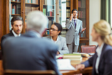 Wall Mural - Lawyers talking on cell phone in chambers