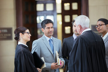 Judges and lawyers talking in courthouse