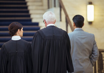 Wall Mural - Judges and lawyer walking through courthouse together