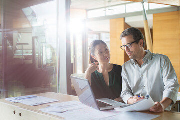 Business people working on laptop in office