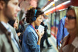 © KOTO - Woman listening to headphones in train station