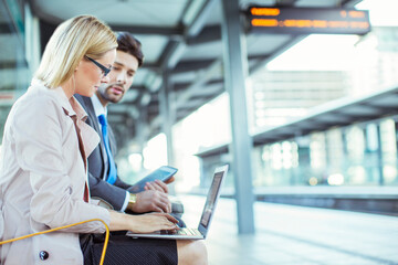 Wall Mural - Business people using laptop at train station