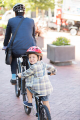 Wall Mural - Portrait smiling boy riding tandem bicycle with businessman father