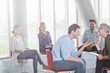 © KOTO - Business people talking and laughing face to face in meeting