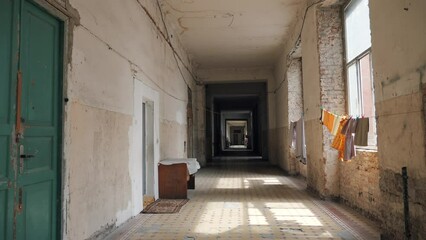 Wall Mural - Corridor of abandoned ruined building inside which refugees now live as shelter.