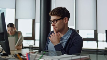 Computer guy looking screen on office. Thoughtful engineer checking code problem