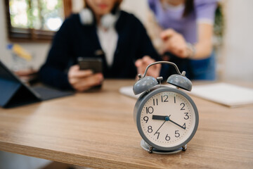 Wall Mural - alarm clock on the desk. business working in modern office building or home at night using laptop..