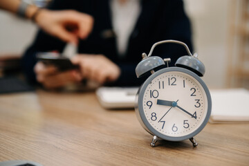 Wall Mural - alarm clock on the desk. business working in modern office building or home at night using laptop..