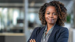Empowered Elegance: Confident Black Businesswoman Smiling againstt a Blurred Office Background