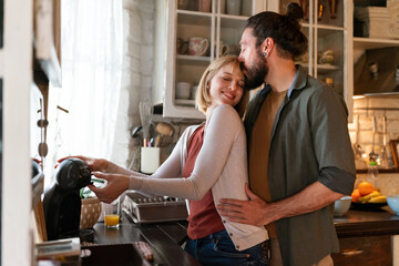 Wall Mural - Lovely multiethnic couple spends quality time together smiling at home. People happiness concept.