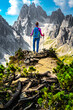 © Michael - Athletic woman enjoys view on Cadini group from epic view point in the morning. Tre Cime, Dolomites, South Tirol, Italy, Europe.