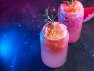 Wall Mural - grapefruit tonic glasses with crushed ice, grapefruit slice and rosemary. color light background