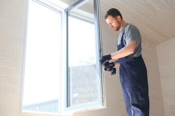 Process of construction new and modern modular house from composite sip panels. Worker man in special protective uniform wear working on building development industry of energy efficient property.