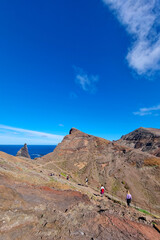 Wall Mural - Tourists walk on the slopes of the island in the ocean.