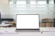 © insta_photos - Laptop device mock up template design on office workplace desk, white mockup empty blank computer screen on office work table business web technology at modern workspace, closeup.
