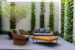 two stylish wooden chairs with cushions and a small wooden table at a balcony of a room in a resort, surrounded by garden