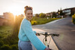 © Halfpoint - Young woman on electro bicycle, concept of commuting and ecologic traveling.