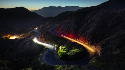Wall Mural - night time lapse of traffic on a road winding through the mountains near los angeles.
