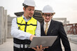 © chachamp - Portrait two caucasian engineer man working with notebook computer at precast site work