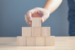 © death_rip - hand of a businessman stacking wood empty eight blocks with copy space for text or symbols, development concept for growth success process.