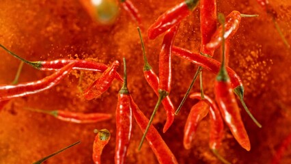 Poster - Super slow motion of flying and rotating red chilli peppers. Filmed on high speed cinema camera, 1000 fps, placed on high speed cine bot, following the target. Black background. Speed ramp effect.