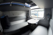 Compartment and berth with bed-linen packages in Railways First Class sleeping carriage of a passenger train, interior